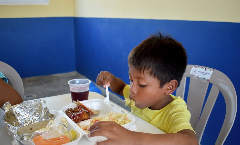 A young boy eating lunch