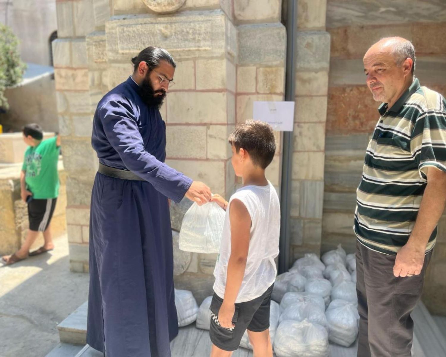 A large group of kids smiling for the photo. 