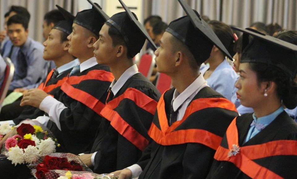 a line of young adults at a graduation ceremony