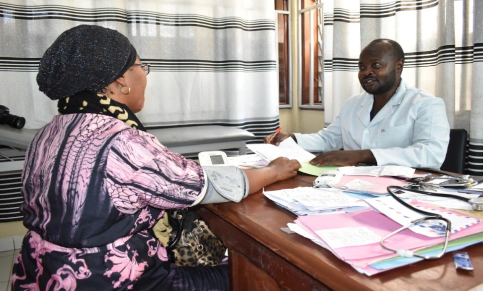 two people sitting in an office sharing documents