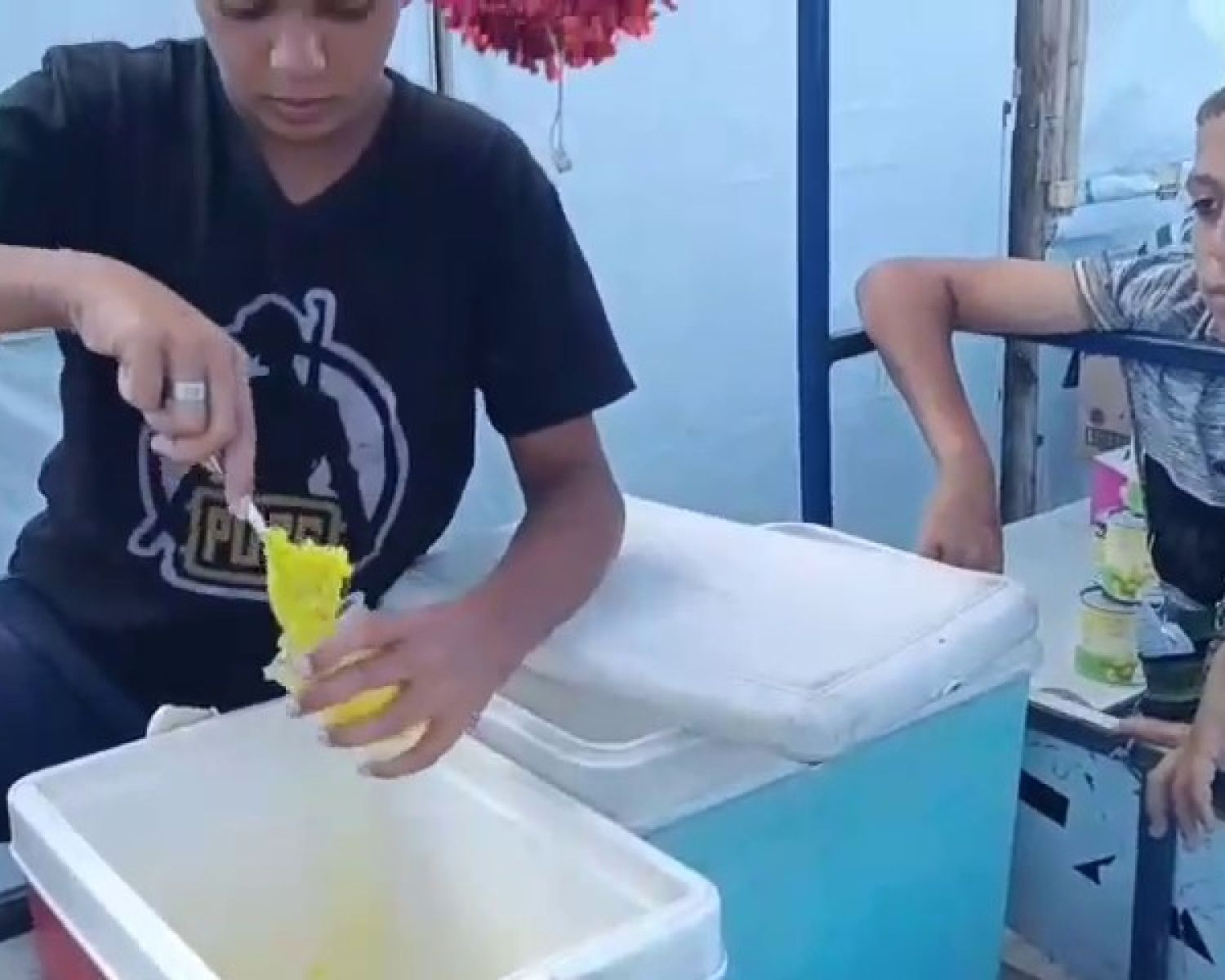 A young girl with face paint on her cheek looking at the camera. 